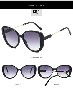 Detail view of stylish square cat-eye sunglasses with purple gradient lenses and gold temples