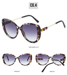 Detail view of tortoiseshell cat-eye sunglasses with purple gradient lenses and gold legs
