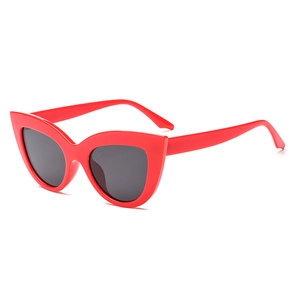 Fashionable oversized red cat eye sunglasses with dark lenses for a trendy retro look