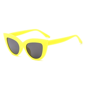 Fashionable bright yellow cat-eye sunglasses with oversized frames and dark lenses for women