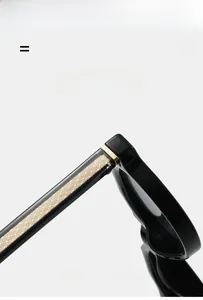 Detail view of black frame temples with golden mesh texture and premium metal hinges