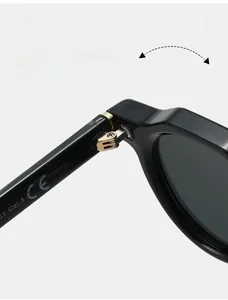 Detail of durable metal hinges and CE certification marking on vintage round sunglasses