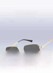 Detail of small hexagonal metal sunglasses with golden frame and dark lenses