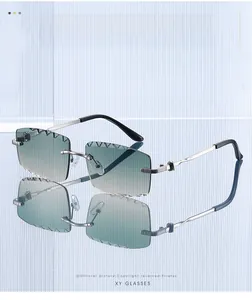 Detail of rimless square sunglasses with green gradient lenses and silver metal temples