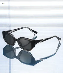 Close-up of geometric black sunglasses with irregular frame and textured material details