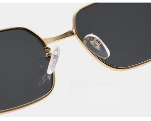 Macro shot of comfortable clear nose pads on gold metal frame rectangle sunglasses