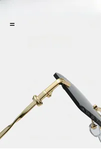 Detailed macro view of gold metal temples with artistic twist design on rimless sunglasses