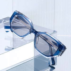 Geometric diamond-shaped sunglasses in translucent blue frame with clear accents