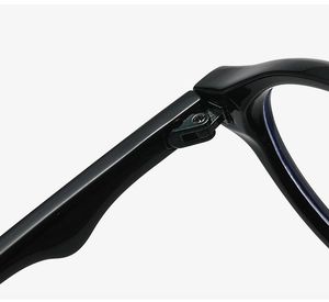 Macro detail of high-quality metal hinges on sleek black oval glasses frame