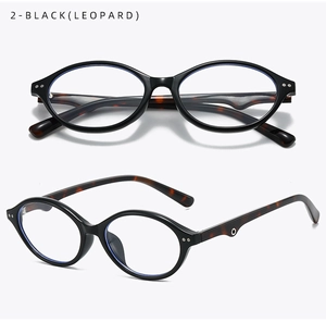 Detail view of oval black eyewear frames with leopard print temples and soft nose pads