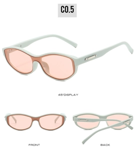 Detail view of mint green oval sunglasses with orange lenses and silver metal temple accents