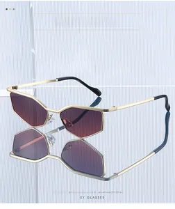 Macro shot of futuristic geometric metal sunglasses with dark red lenses on glass texture