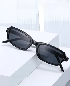 Detail of black rectangular sunglasses with silver three-dot rivets and dark lenses