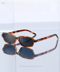 Detail shot of vintage tortoise shell rectangle sunglasses with dark gray lenses