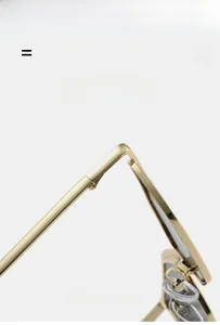 Detail of gold metal glasses frame with fine hinges and adjustable silicone nose pads
