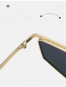 Detail view of durable metal hinges on gold polygon sunglasses with dark gray lenses