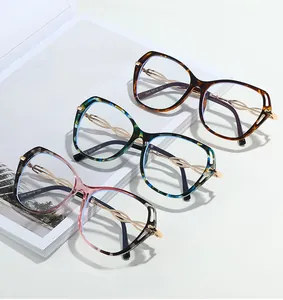 Detailed view of butterfly frames with twisted metal temples and hollow gold accents