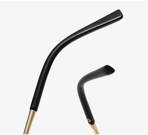 Detail of golden metal twist temple with black tips on butterfly eyeglass frames