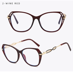 Macro detail of wine red cat-eye frame with golden metal braided hollow temple design