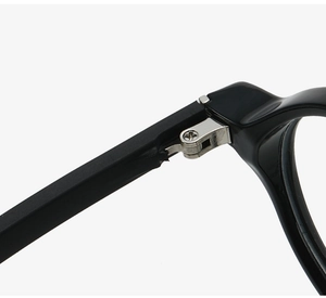 Detailed close-up of durable metal hinges on classic black round glasses frames