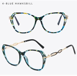 Macro detail of blue tortoiseshell cat-eye glasses with golden spiral twisted metal temples