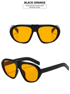 Detail view of bold black square sunglasses featuring vibrant orange tinted lenses