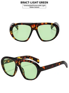 Close-up of tortoise shell sunglasses with light green lenses and wide retro frames