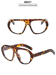 Detail view of tortoiseshell oversized blue light blocking glasses with floral frame design