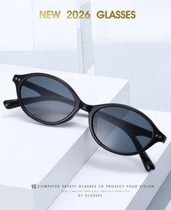 Macro detail of black oval computer safety glasses with silver rivets on a white background