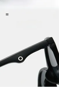 Detail shot of black round sunglasses hinge featuring a metal ring decorative element