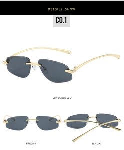 Detail view of grey rimless lenses and gold metal temples of these fashion sunglasses