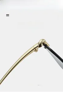 Detailed macro shot of the durable metal hinge connecting the golden sunglasses frame