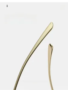 Detail of curved gold metal eyewear temples designed for a comfortable ergonomic fit