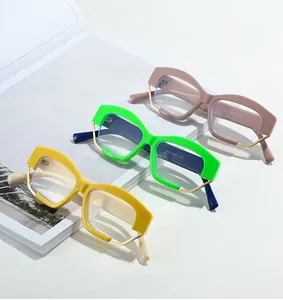 Close-up of stylish thick-frame glasses in ginger, bright green, and dusty pink shades