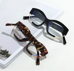 Detail of oversized irregular frames in black and tortoise textures with metal temples