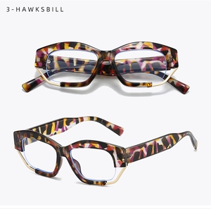 Detail view of colorful hawksbill geometric frames with gold metal trim and artful pattern