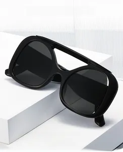 Detail of oversized Y2K sunglasses with black thick frame on a geometric pedestal