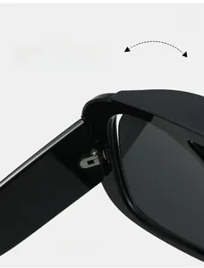 Detailed close-up of durable texture hinges on oversized Y2K black sunglasses