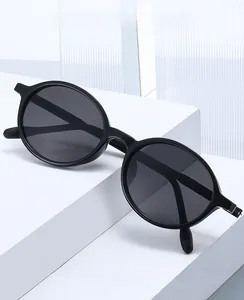 Close-up of TR90 round frame sunglasses with matte black finish and hinge details
