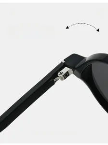 Close-up of durable silver metal hinges on glossy black TR90 sunglasses frame