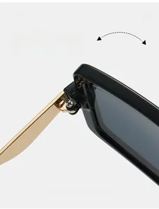 Macro detail of high-quality black sunglasses showing durable gold metal hinge texture