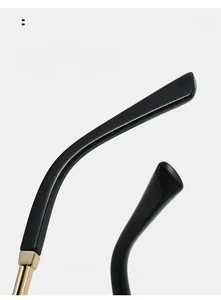 Detail of ergonomic curved black temples with premium gold metal hinges for comfort