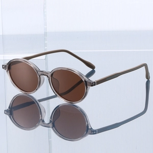 Classic round sunglasses with transparent grey TR90 frames and dark brown lenses
