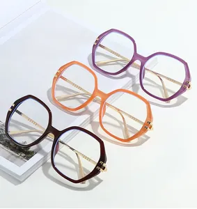 Three polygon glasses frames in purple, orange, and brown with gold metal temples