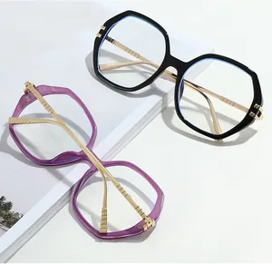 Detail view of stylish oversized polygonal frames with elegant gold metal temples and hinges