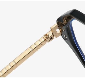 Macro shot of gold metal temples with striped texture and durable eyeglass hinges