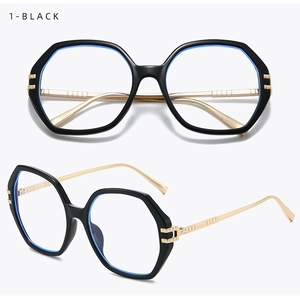 Detail of black oversized polygonal glasses with gold metal textured temples