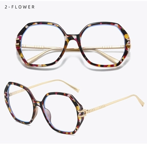 Close-up of polygonal floral eyewear frame with gold metal temples and blue light lens