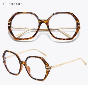 Detail view of leopard print polygonal frames with gold metal temples and blue light lenses