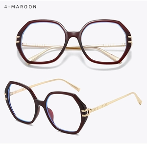 Macro shot of maroon polygonal frames with gold metal temples and blue light lenses